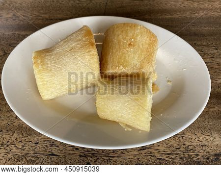 Fried Cassava Slices On A White Plate. Focus Selected