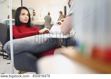 Portrait Of Bored Lady Client On Manicure And Pedicure Appointment In Beauty Salon. Wellness Procedu