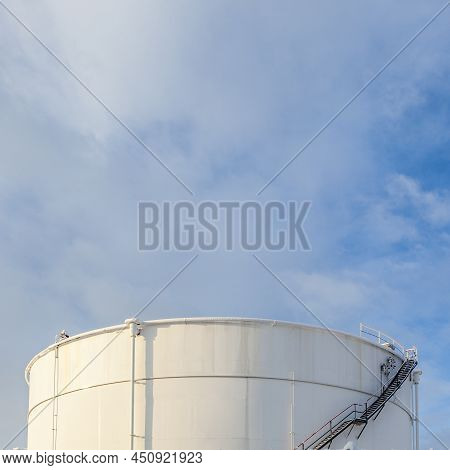 White Tanks In Tank Farm With Iron Staircase In Snow