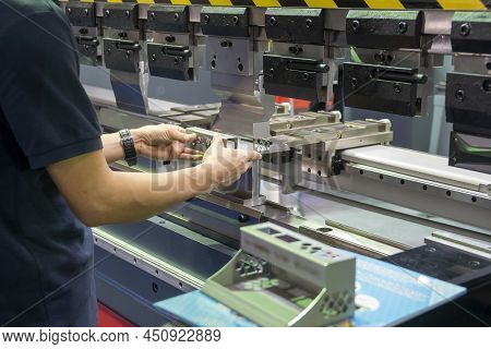 The Hand Of Technician Operator Working With Hydraulic Press Brake Bending Machine. The Sheet Metal 