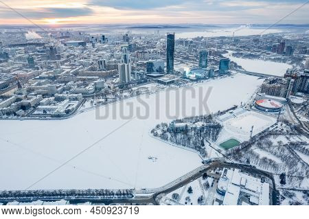 Yekaterinburg Aerial Panoramic View In Winter At Sunset. Yekaterinburg City And Pond In Winter.