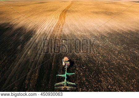 Aerial View. Tractor Plowing Field In Spring Season. Beginning Of Agricultural Spring Season. Cultiv