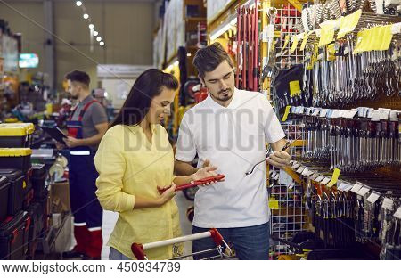 Young Couple At A Diy Store Or Hardware Shopping Mall Shopping For Tools For Home Repairs