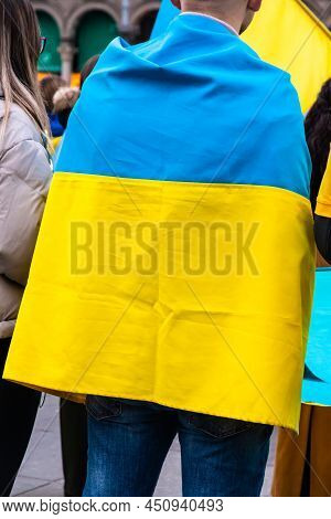 Young Man Wrapped In The Ukrainian Flag In A Protest Against Russia Invasion