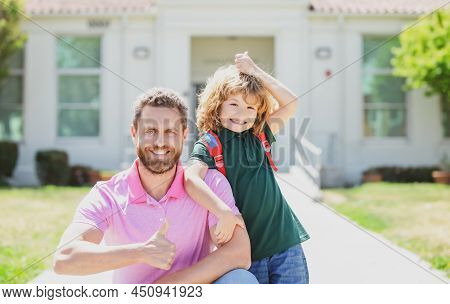Father Walking Son To School. Parent And Pupil Schoolboy With Thumbs Up Sign. Happy Face.