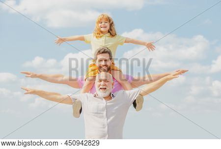 Fathers Day. Father And Son With Grandfather Raising Hands Or Open Arms Flying. Men Generation.