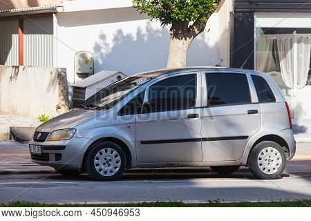 Side; Turkey - March 05 2022:   Silver Fiat Idea  Is Parked  On The Street On A Warm Day