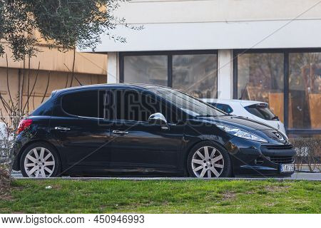 Side; Turkey - March 05 2022:    Black Peugeot 207   Is Parked  On The Street On A Warm Summer Day