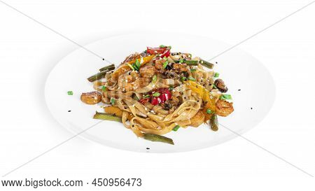 Wok Noodles With Seafood Isolated On A White Background. Pasta With Shrimp And Mussels.