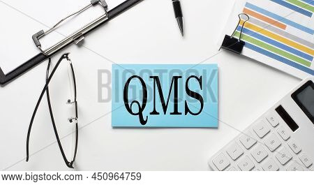 Stickers With Chart,calculator And Paper With Text Qms On A White Background