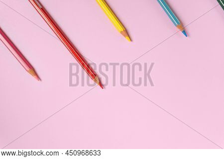 Color Pencils On A Light Pink Background. Top View With Space For Text. Back To School Concept. Flat