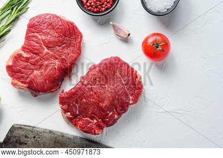 Raw Rumpsteak, Farm Beef Meat With Seasonings, Rosemary, Garlic And Butcher Cleaver. White Textured 
