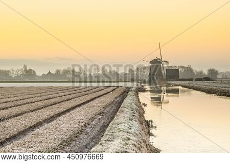 Breezand, The Netherlands. March 2022. Sunrise In The Polder With Mill In Background.