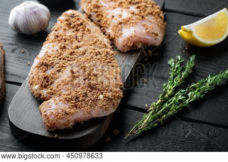 Crispy Garlicky Chicken Raw Ingredient, On Black Wooden Background