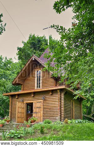 Old Church Building In Dukora Village Estate In Belarus With Line Of Flowers And Plants In Foregroun