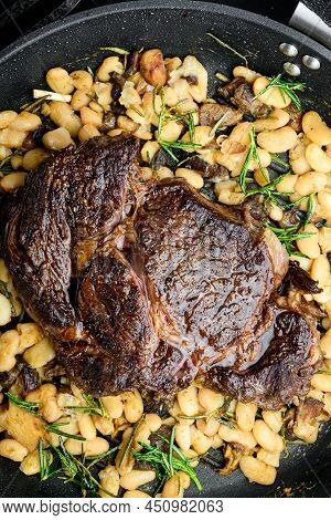 Grilled Marbled Beef Meat Rib Eye Steak And Vegetables Set, On Frying Cast Iron Pan, On Black Stone 