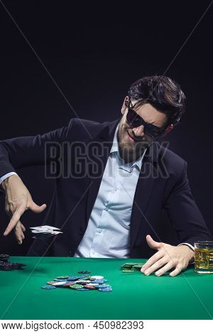 Emotional Handsome Caucasian Brunet Pocker Player At Pocker Table With Chips And Cards While Playing