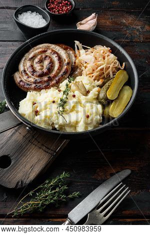 Fried Bavarian German Nürnberger Sausages With Sauerkraut, Mashed Potatoe In Cast Iron Frying Pan, O