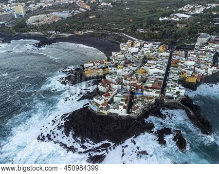 Aerial View On Colorful Houses And Black Lava Rocks In Small Village Punta Brava Near Puerto De La C