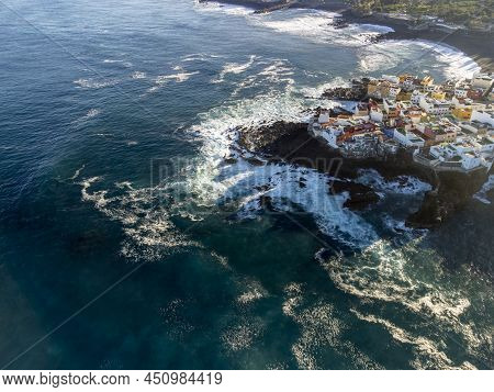 Aerial View On Colorful Houses And Black Lava Rocks In Small Village Punta Brava Near Puerto De La C