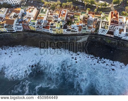 Aerial View On Colorful Houses And Black Lava Rocks In Small Village Punta Brava Near Puerto De La C