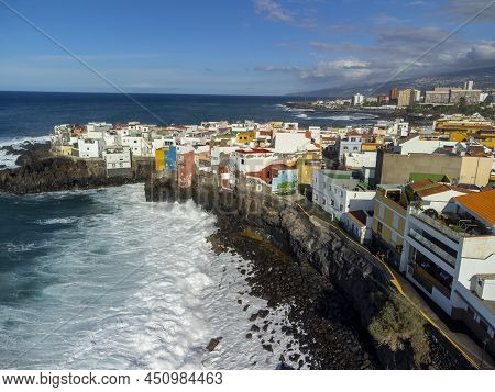 Aerial View On Colorful Houses And Black Lava Rocks In Small Village Punta Brava Near Puerto De La C