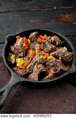 Mongolian Beef, Pieces Of Beef Stewed In Soy Sauce Set, In Cast Iron Frying Pan, On Old Dark  Wooden