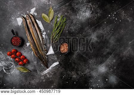 Fried River Lamprey Vacuum Pack Set, On Black Dark Stone Table Background, Top View Flat Lay, With C
