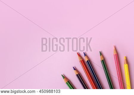 Color Pencils On A Light Pink Background. Top View With Space For Text. Back To School Concept. Flat