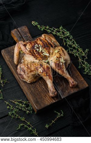 Spatchcocked Poussins, With Chimichurri Sauce, On Black Wooden Background
