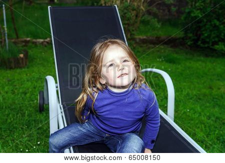 Cute Little Girl On Sling Chair
