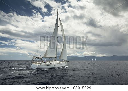 AEGEAN SEA, GREECE - MAY 5, 2014: Unidentified sailboats participate in sailing regatta 