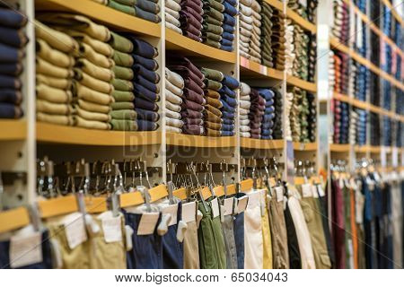 Neat stacks of folded clothing on the shop shelves