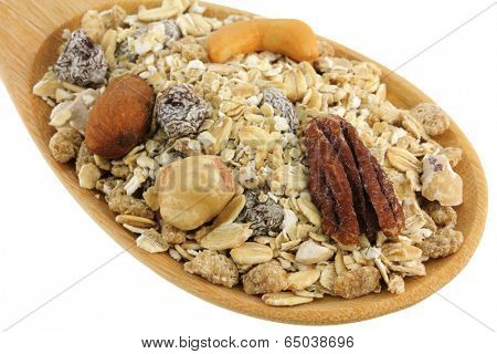 A spoon of Fruit, Nut, and Fiber Muesli isolated on white background