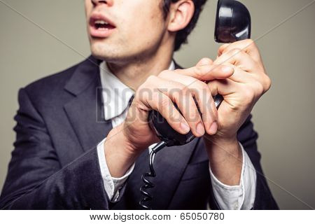Businessman Covering The Phone