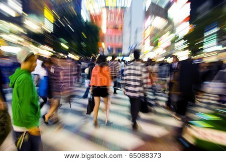 The famous Shibuya crossing at night. Long exposure with zooming for impact.