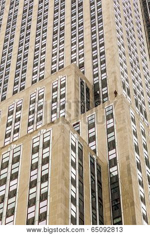 Facade Of Skyscraper With Statue Of Man