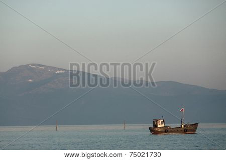 fishing boat on the background of big mountain
