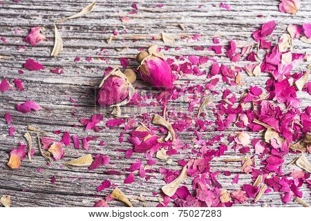 Dry rose buds on rustic wooden table