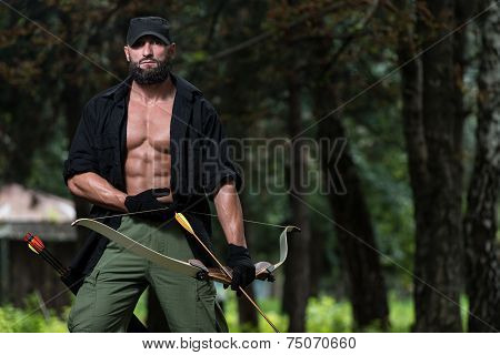 Man With A Bow And Arrows In Woods