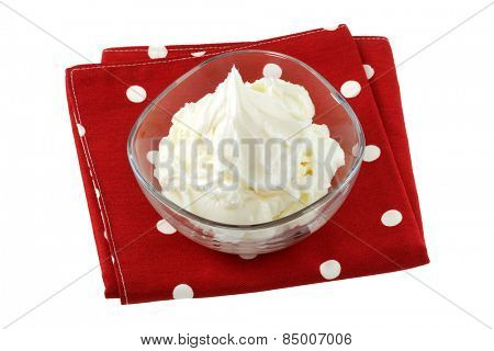 A bowl of All vegetable shortening, on red cloth isolated on white background
