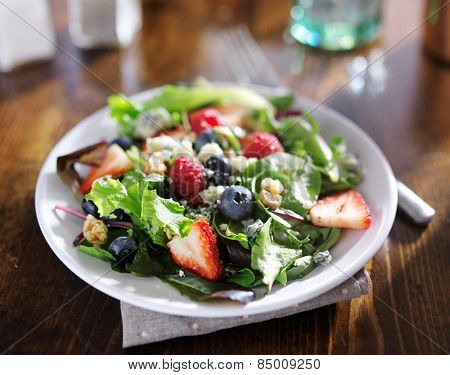 tasty mixed berry salad with blue cheese crumbles and walnuts