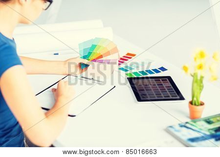 interior design, renovation and technology concept - woman working with color samples for selection