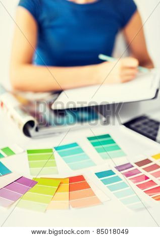 interior design and renovation concept - woman working with color samples for selection