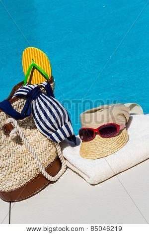 utensils for a nice relaxing vacation day lying next to a swimming pool. relaxation on vacation.