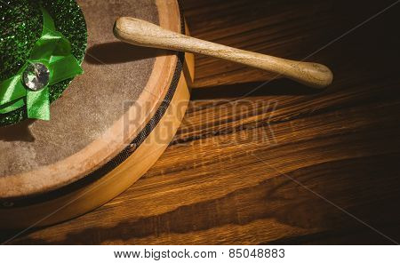 Traditional Irish bodhran and stick on wooden table