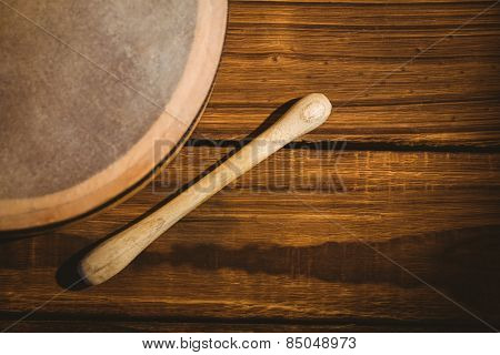 Traditional Irish bodhran and stick on wooden table