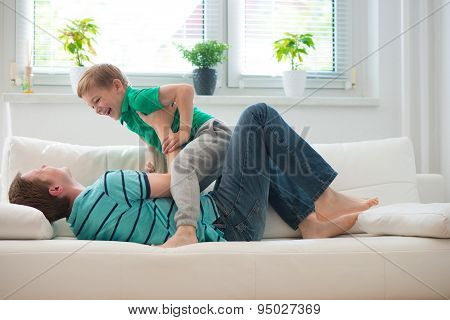 Little Boy Having Fun With Father At Home