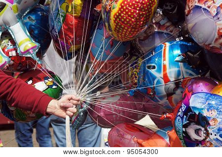 Balloon seller holding colorful balloons