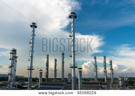 Process Columns of Natural Gas Plant with blue sky and cloud background